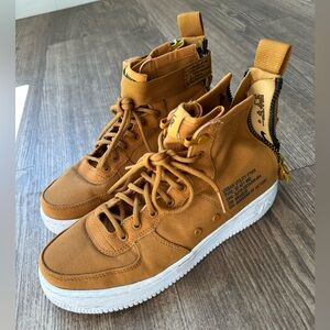 Tan high top Nike shoes